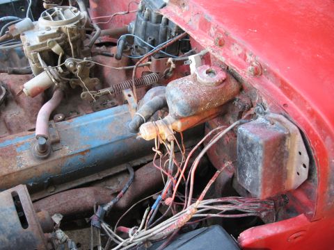 1983 Chevrolet Silverado 1500 - Close-up view of the engine bay of a 1983 Chevrolet Silverado 1500, showing various mechanical components and wiring.