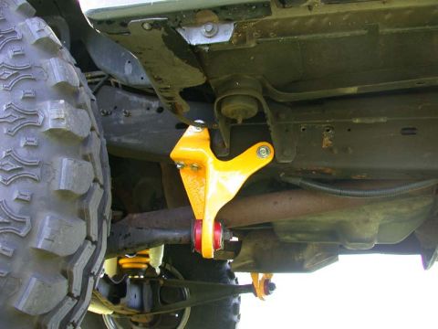 1996 Ford Bronco - Close-up of the undercarriage, highlighting a yellow suspension component and a large off-road tire.