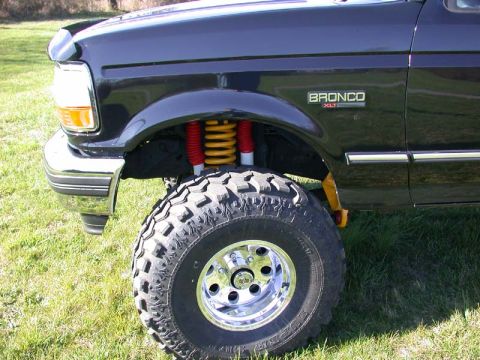 1996 Ford Bronco - Front corner view of a 1996 Ford Bronco XLT showing the wheel and suspension.