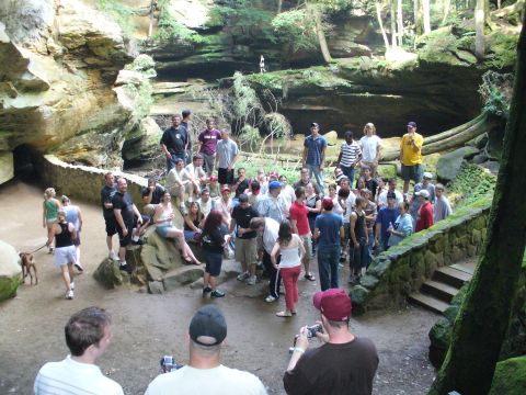 1991 Ford Probe - A large group of people are gathered in a scenic canyon, with some standing and others sitting on rocks.