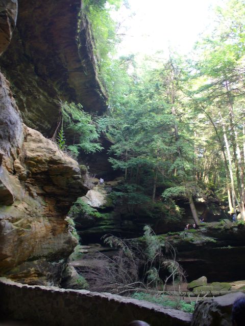 1991 Ford Probe - Hikers explore a scenic gorge with steep rock walls and lush green trees overhead.