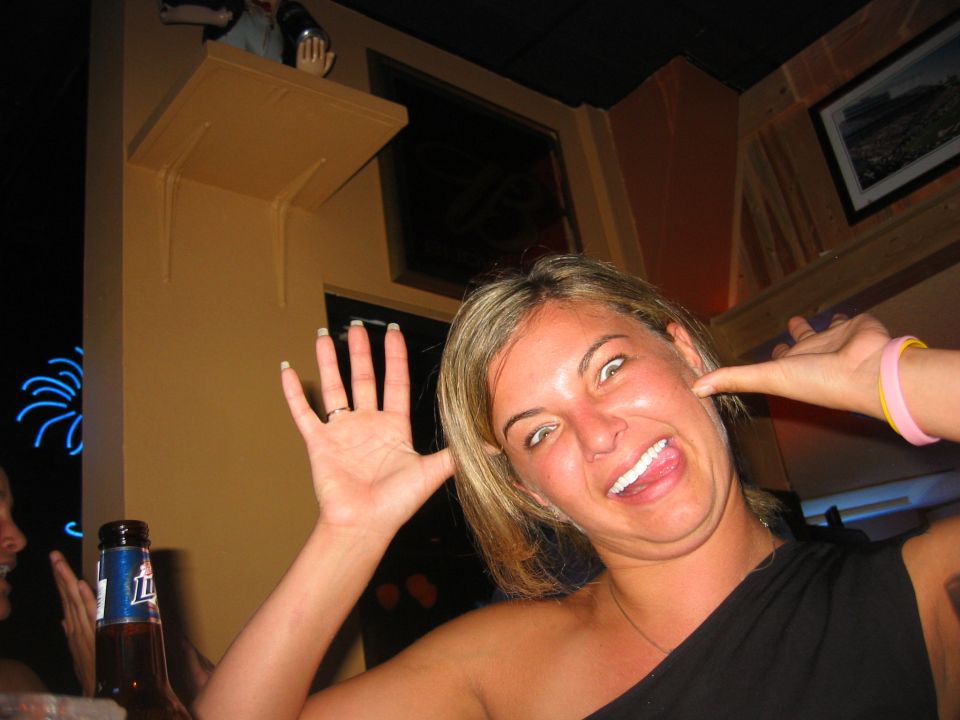 Person posing playfully inside a bar