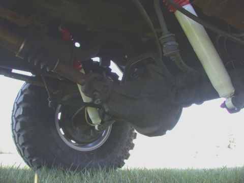 1996 Ford Bronco - Underside view shows the rear axle, differential, and suspension components of a vehicle.