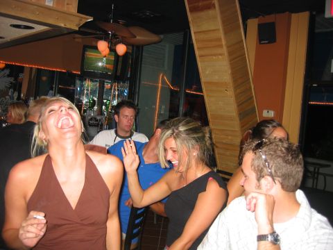 1989 Ford Bronco - A group of friends enjoy a night out at a bar, with one woman laughing heartily.