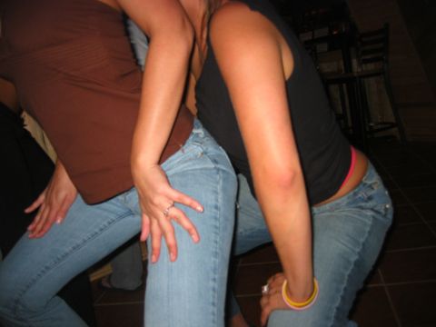 1989 Ford Bronco - Two women in jeans and tops are posing for a photo indoors.