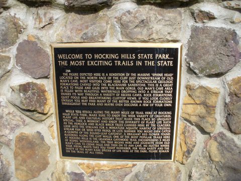 1991 Ford Probe - A plaque mounted on a stone wall provides information about Hocking Hills State Park and its trails.
