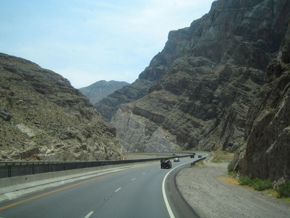 Curving highway through a rugged rocky desert canyon
