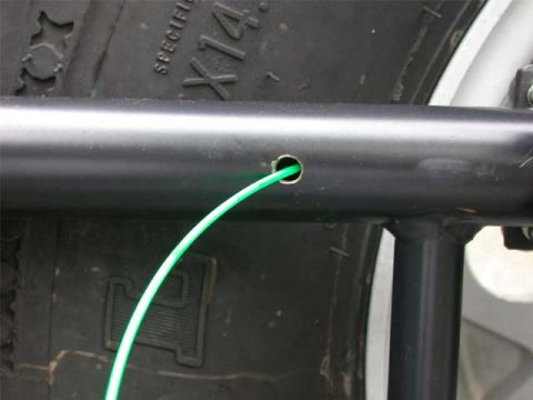 1996 Ford Bronco - Here I drilled the top hole where the wire will exit to the antenna plate, and inserted the "snake".