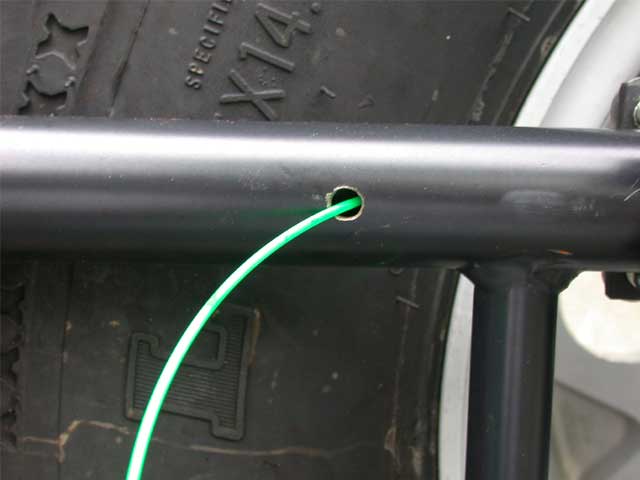 Here I drilled the top hole where the wire will exit to the antenna plate, and inserted the "snake".