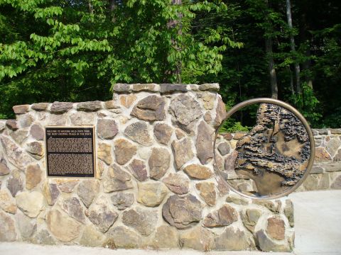 1991 Ford Probe - Welcome to Hocking Hills State Park, a stone wall with an informational plaque and a decorative circular relief.