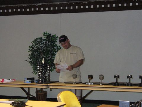 1991 Ford Probe - A man stands at a table with several engine pistons displayed as trophies.