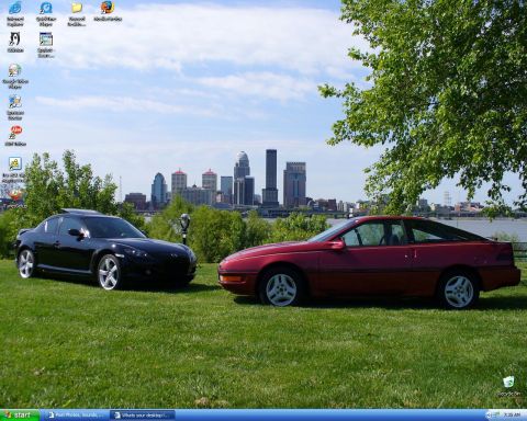 1991 Ford Probe - Windows XP desktop screenshot whose wallpaper shows a black Mazda RX-8 sedan and a red first-generation Ford Probe hatchback coupe parked s…
