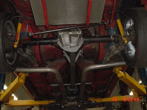 1993 Ford Mustang - Underside view shows the rear axle, suspension components, and exhaust system of a vehicle.