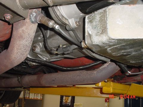 1993 Ford Mustang - Underside view of a vehicle's exhaust system and transmission, showing various mechanical parts.