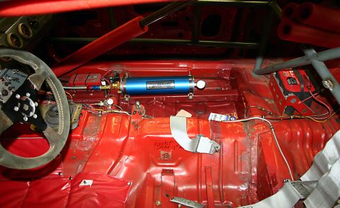 1993 Ford Mustang - Interior view of a modified car, showing racing equipment and a roll cage.