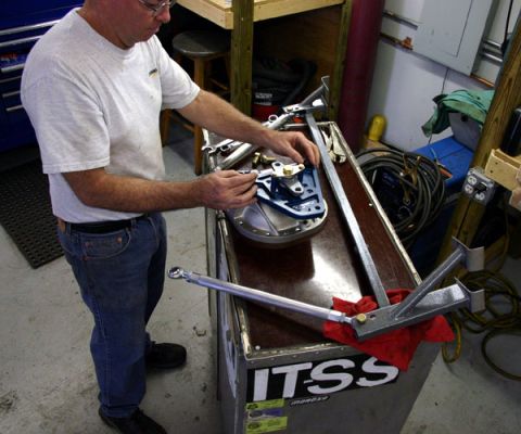 1993 Ford Mustang - A mechanic works on a differential cover, likely for a vehicle rebuild project.