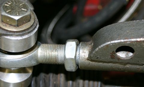 1993 Ford Mustang - A detailed view of an automotive mechanical linkage, focusing on the connection point and hardware.