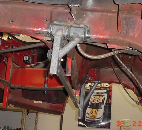 1993 Ford Mustang - Custom metalwork on a car frame, with a poster of a 1996 Saleen Mustang visible.