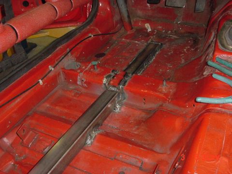 1993 Ford Mustang - Car interior with roll cage and floor modifications, possibly for racing or performance enhancement.