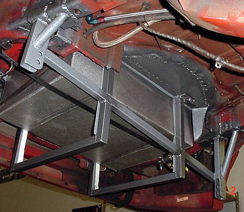 1993 Ford Mustang - The undercarriage of a 1993 Ford Mustang shows a custom fuel tank installation with a metal support frame.