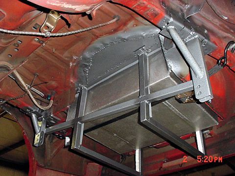 1993 Ford Mustang - Custom fuel tank installation with metal support structure visible on the undercarriage of a vehicle.