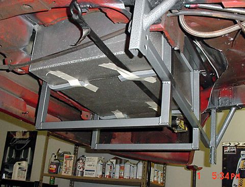 1993 Ford Mustang - Custom fuel tank installation in progress under a vehicle's chassis.