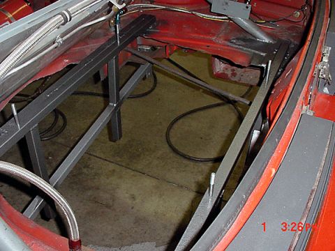 1993 Ford Mustang - A car's interior is being worked on, with a metal frame installed over the floor area.