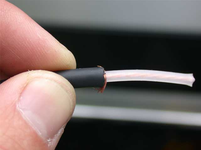 Remove some of the outer cable, along with the shielding, exposing the core. Neatly trim of the braid.
