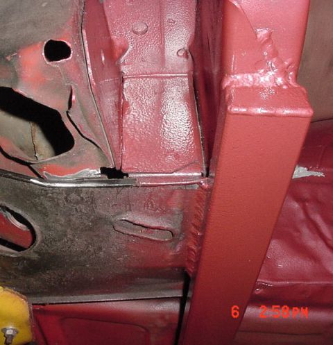 1993 Ford Mustang - Close-up view of underbody frame repair work, showing structural components and a date stamp.