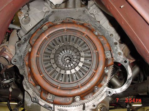 1993 Ford Mustang - Close-up view of a vehicle's clutch assembly and flywheel housing, showing mechanical components.