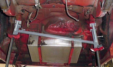 1993 Ford Mustang - The underside of a vehicle is shown with a fuel tank and supporting equipment.