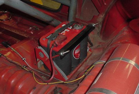 1993 Ford Mustang - Interior view of a car's cabin, highlighting a red battery and safety equipment.
