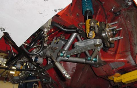 1993 Ford Mustang - Close-up view of a vehicle's front suspension system, showing various metal components and a shock absorber.
