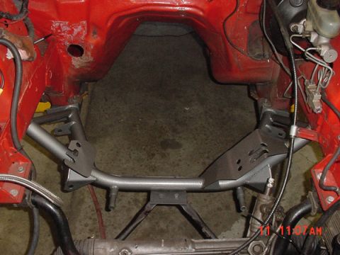 1993 Ford Mustang - Close-up view of a vehicle's engine bay frame, showing structural modifications and components.