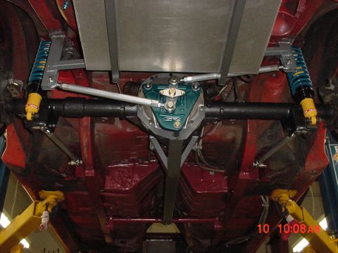 1993 Ford Mustang - Custom rear suspension components are visible on the underside of a vehicle, lifted for service.