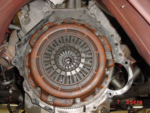 1993 Ford Mustang - Close-up view of a vehicle's clutch assembly and part of the engine block.