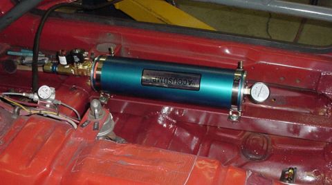 1993 Ford Mustang - An Accusump oil accumulator is installed in the interior of a red vehicle.