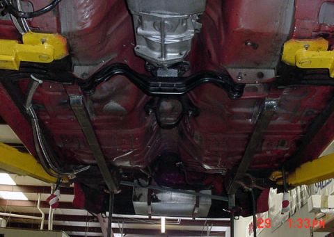 1993 Ford Mustang - The undercarriage of a vehicle is shown, with the transmission and exhaust components visible.