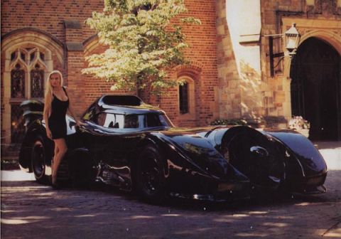 1988 Mercury Grand Marquis - Scanned publicity-style photo of the black 1989 Batman movie Batmobile parked on a cobblestone drive outside a Gothic brick building, viewe…