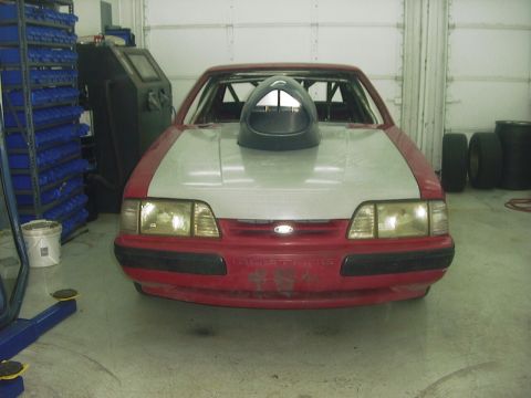 1990 Ford Mustang - Front view of a modified 1990 Ford Mustang with a prominent hood scoop.