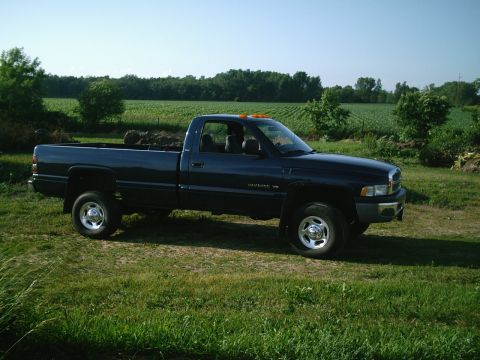 2001 Dodge 2500 - This dark blue 2001 Dodge 2500 pickup truck is seen from the side in a rural setting.