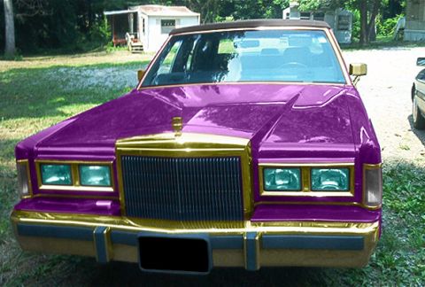 1985 Ford Crown Victoria LTD - Customized sedan with a unique purple and gold paint scheme, seen from the front.