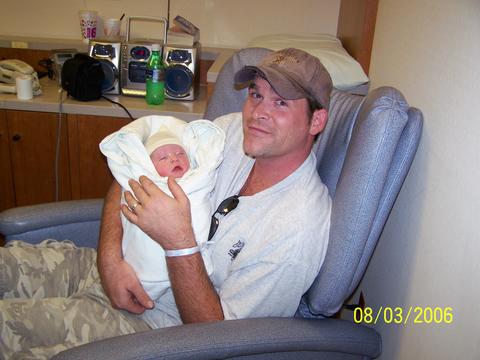 1992 Ford C-250 (Centurion Conversions) - A man holds a newborn baby in a hospital room setting, with a date stamp indicating August 3, 2006.