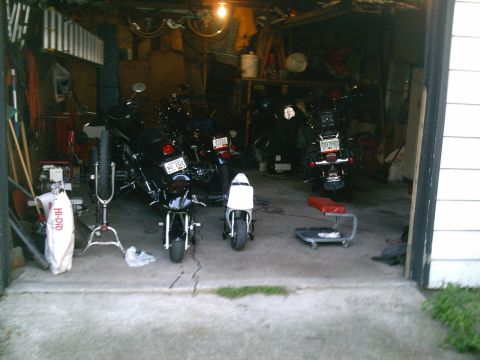 2001 Dodge 2500 - Motorcycles are stored in a garage with tools and supplies.