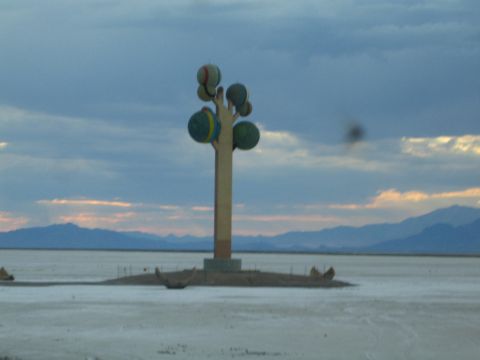 1990 Ford Bronco - tall column sculpture topped with several colorful spheres stands on a flat white expanse beneath a cloudy dusk sky.