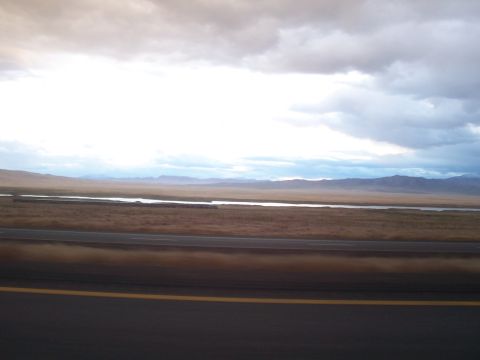 1994 Ford F-150 - Wide landscape view with a river and distant mountains under a cloudy sky.