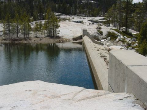 1986 Ford Bronco - A scenic view of a dam and reservoir in a mountainous, wooded landscape.