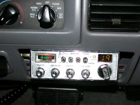 1996 Ford Bronco - My *peaked* Cobra 25 LTD Classic. I took out the ash tray, being that it got NO USE, and jammed her right up in there. Nice snug fit.