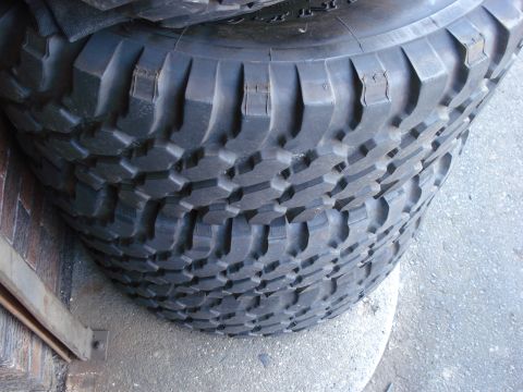 1994 Ford Bronco - A stack of off-road tires is visible, with the Supermotors.net logo in the lower right corner.