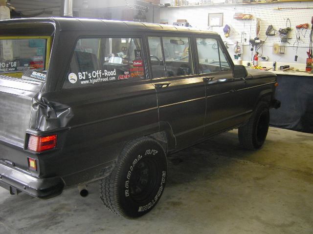 Black 1977 Jeep Wagoneer, rear quarter view, with BJ's Off-Road sticker